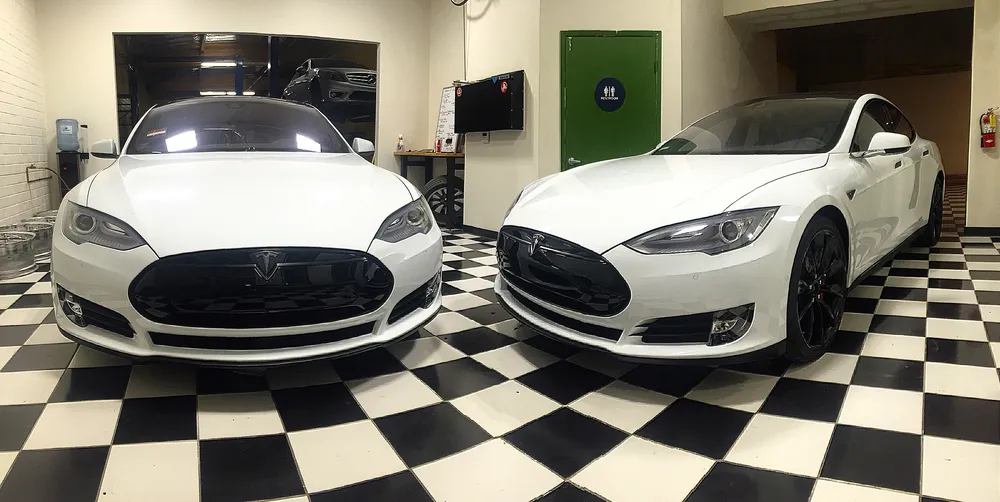 Two white Tesla Model S with blackout packages at the Vaderwerks shop