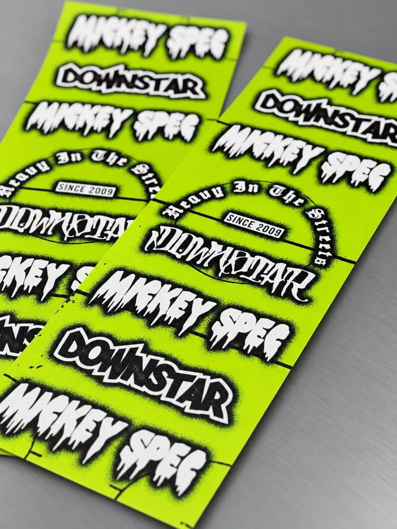 Downstar Mickey Spec sticker sheets in neon green, printed by Vaderwerks