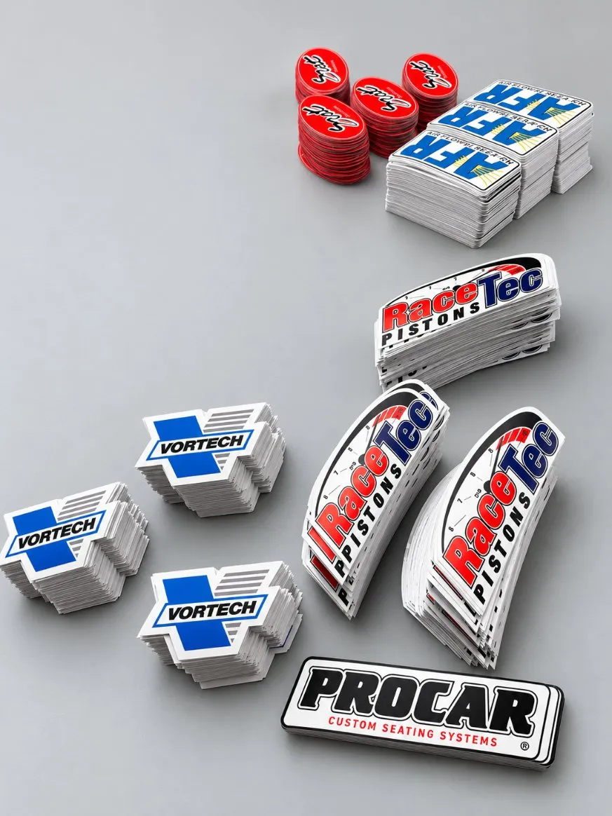 Stacks of die-cut stickers for Vortech, RaceTec Pistons and AFR, printed by Vaderwerks