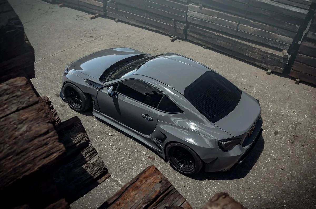 Grey widebody sports coupe wrap overhead view by Vaderwerks