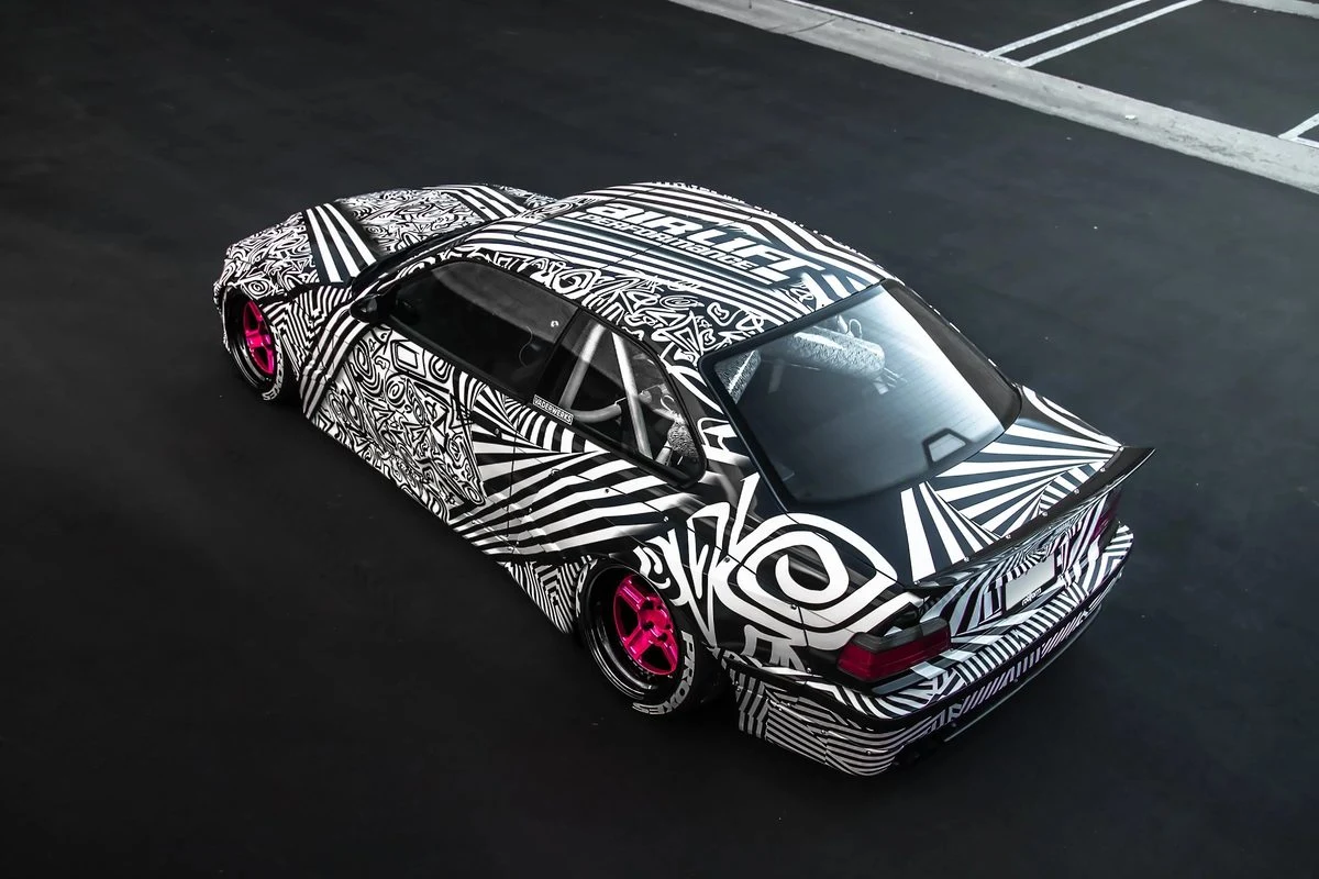 Black and white patterned full wrap with pink wheels by Vaderwerks