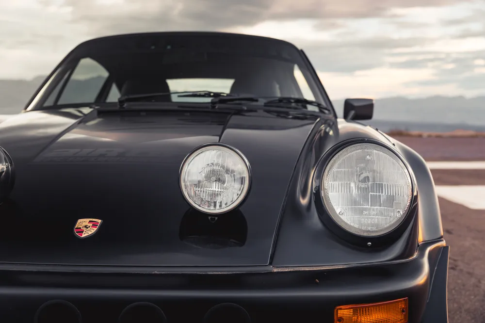 Matte black Porsche 911 RWB headlight and front fender detail